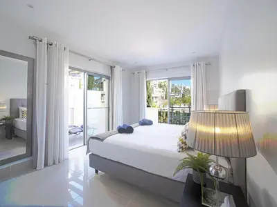 a bedroom with a large bed and a large window at Apartment Pine Hills Esmeralda by Interhome in Vilamoura