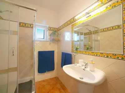 a bathroom with a sink and a shower with a mirror at Villa Mariana by Interhome in Galé