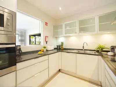 a bathroom with two sinks and a tub and a toilet at Apartment Pine Hills Ametista by Interhome in Vilamoura
