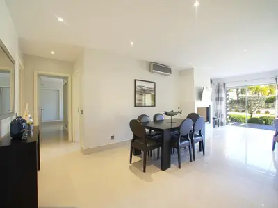 a dining room with a black table and chairs at Apartment Pine Hills Ametista by Interhome in Vilamoura