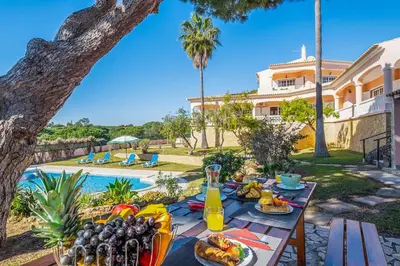 a table with food and drinks in front of a house at Villa Mar & Sol by Algarve Vacation in Albufeira
