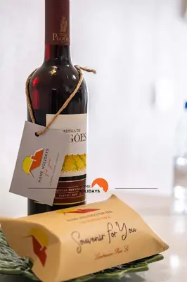 a bottle of wine in a box on a table at #099 T1 Caliços by Home Holidays in Albufeira