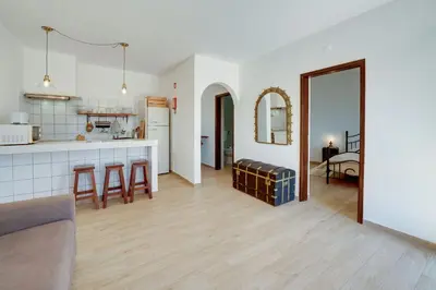 a kitchen and living room with a couch and a table at Quinta Coelho in Guia