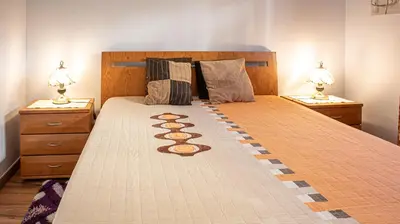 a bedroom with a bed with two night stands and two lamps at Casa da Praia - São Rafael - BY BEDZY in Albufeira