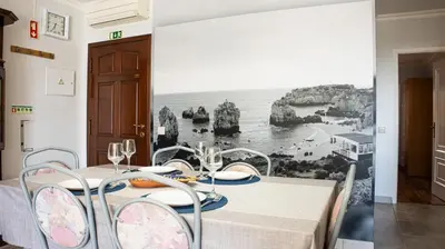 a dining room with a table with a view of the ocean at Casa da Praia - São Rafael - BY BEDZY in Albufeira