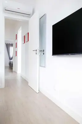 a living room with a flat screen tv on a wall at Oura Villa V2 Flores in Albufeira