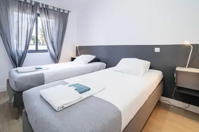 a room with two beds and a window at Oura Villa V2 Flores in Albufeira