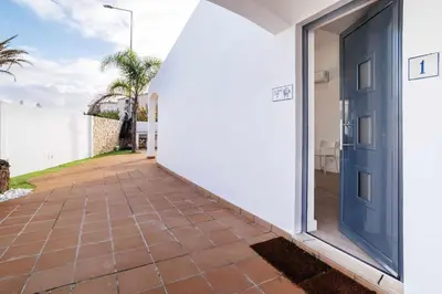 a door to a house with a tile walkway at Oura Villa V2 Flores in Albufeira