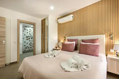 a bedroom with a large bed with towels on it at Oura Sunset Apartement in Albufeira