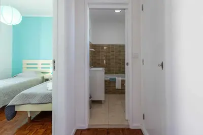 a bedroom with a bathroom with a bed and a tub at T3 Apartamento do Tenis in Albufeira