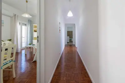 a hallway with white walls and a wooden floor at T3 Apartamento do Tenis in Albufeira