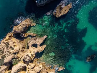 an aerial view of the ocean and rocks at Villa Molucas by Algarve Vacation in Albufeira