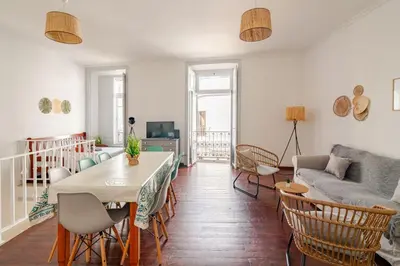 a living room with a table and a couch at Down Town Beach House in Albufeira