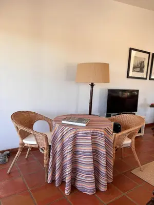 a patio with a couch and tables on a patio at Casa do Cabeçudo in Faro