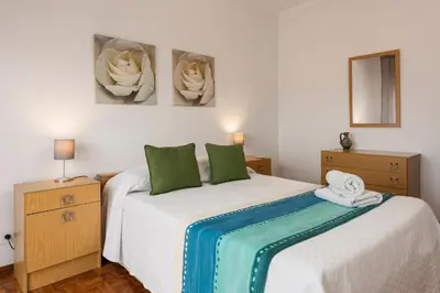 a bedroom with two beds with green pillows at OLIVE - Quarteira in Quarteira