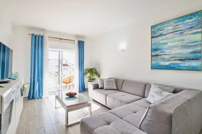 a living room with a couch and a table at Beautifull CentralApart W/pool in Albufeira