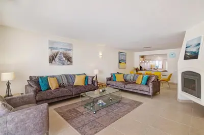 a living room with two couches and a fireplace at Villa Nicola in Vale do Lobo