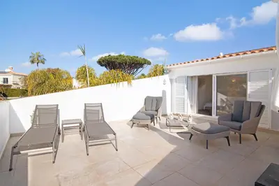 a group of chairs and tables on a patio at Villa Nicola in Vale do Lobo