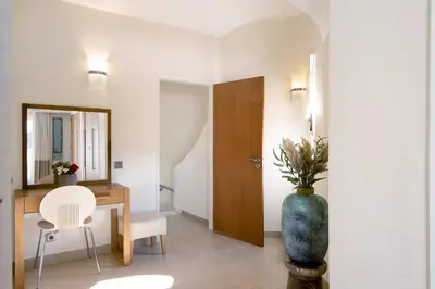 a living room with a table and a vase at Villa Nicola in Vale do Lobo