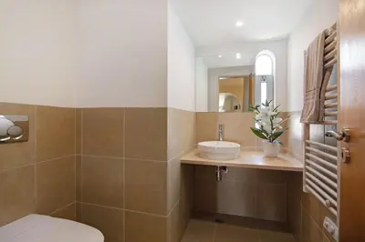 a bathroom with a sink and a toilet and a mirror at Villa Nicola in Vale do Lobo