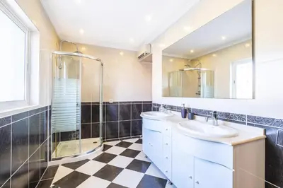 a bathroom with a sink and a shower at Villa Estrelícia - Pool - Free wi-fi - New in Booking in Loulé