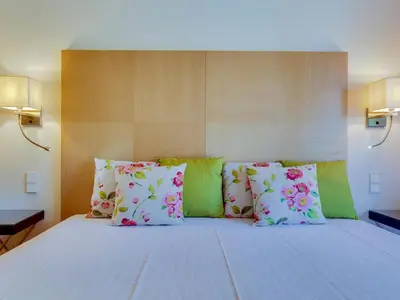 a bedroom with a large bed with colorful pillows at AL - Apartamento Vila Sol F5 AO in Vilamoura