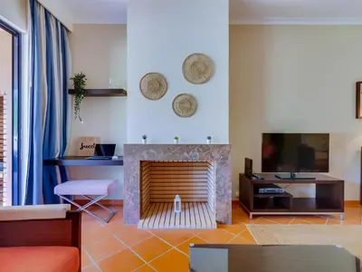 a living room with a fireplace and a tv at AL - Apartamento Vila Sol F5 AO in Vilamoura