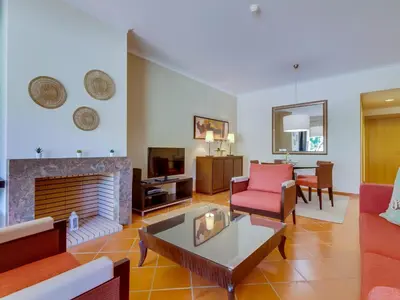 a living room with a couch and a fireplace at AL - Apartamento Vila Sol F5 AO in Vilamoura