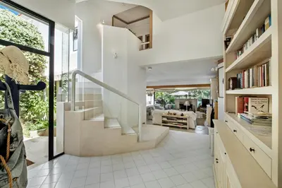 a staircase in a house with a living room at Victory Village Beach Villa - Quinta do Lago in Quinta do Lago