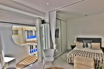a hotel room with a bed and a balcony at Quarteira Mar - Beach Front in Quarteira
