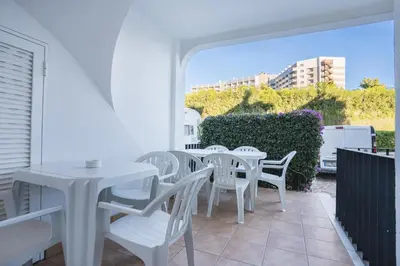 a tree in a yard with a building in the background at #109 Zélio House by Home Holidays in Albufeira