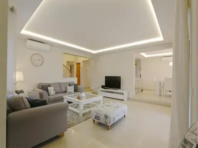 a living room with a couch and a tv at Lovely Vilamoura Villa 4 Bedrooms Villa Pinhal Short Drive To Marina in Quarteira
