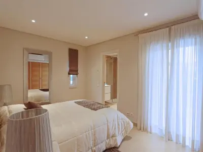 a bedroom with a bed and a large window at Lovely Vilamoura Villa 4 Bedrooms Villa Pinhal Short Drive To Marina in Quarteira