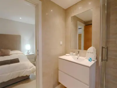 a bathroom with a bed and a sink and a mirror at Lovely Vilamoura Villa 4 Bedrooms Villa Pinhal Short Drive To Marina in Quarteira