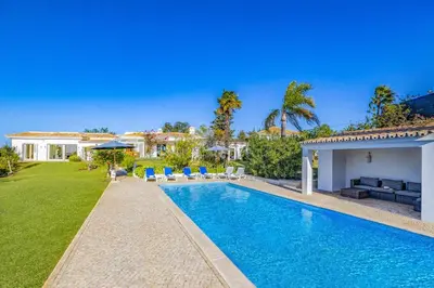 a villa with a swimming pool and a house at Villa Casa do Amendoal by Villa Plus in Albufeira