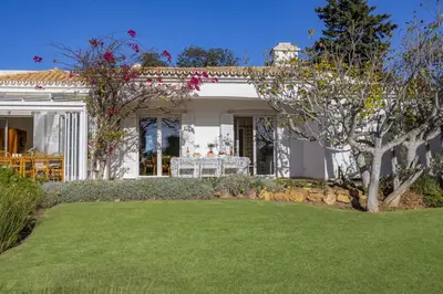 a white house with a lawn in front of it at Villa Casa do Amendoal by Villa Plus in Albufeira