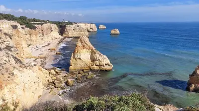 an aerial view of a rocky coastline with the ocean at 