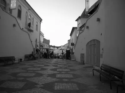an empty street with benches and buildings and people at Sunset Haven in Albufeira - Short walk to Oldtown in Albufeira