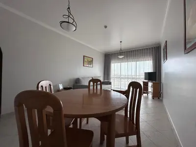 a dining room and living room with a table and chairs at Sunset Haven in Albufeira - Short walk to Oldtown in Albufeira