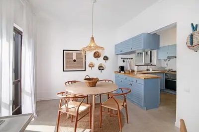 a kitchen and dining room with a table and chairs at Balaia 9 in Olhos de Água