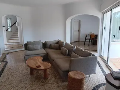 a living room with a couch and a table at Casa Francisco : Family Villa with private pool. Near to beach in Albufeira