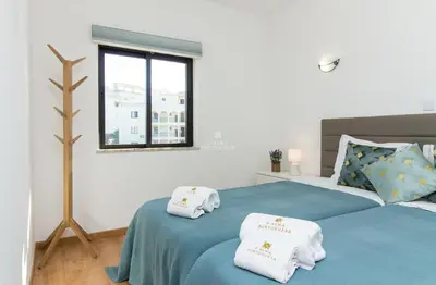 a bedroom with two beds with towels on them at Apartment OuraVale in Albufeira