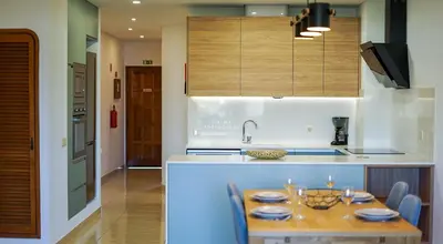 a kitchen with blue cabinets and a dishwasher at Apartment OuraVale in Albufeira