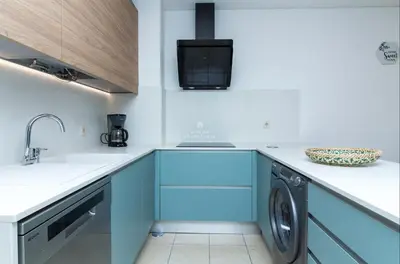 a kitchen and dining room with a table and chairs at Apartment OuraVale in Albufeira