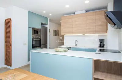 a kitchen and dining room with a table and chairs at Apartment OuraVale in Albufeira