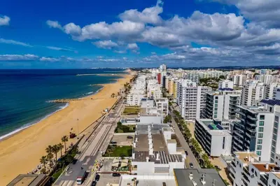 a view of a beach with buildings and the ocean at Terraços de Quarteira Green by Real Properties in Quarteira