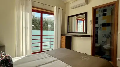 a bedroom with a bed and a bathroom with a window at Marina by Check-in Portugal in Albufeira