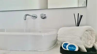 a white bathroom with a sink and a towel at Villa BEA - Clever Details, Luxury, Golf views, Sleeps 10 in Vilamoura