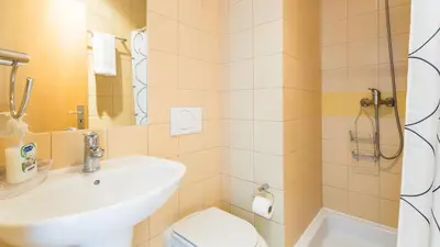 a bathroom with a sink and a toilet and a shower at Central Albufeira 2-B Apt Sleeps 6 Pool Parking in Areias Sao Joao