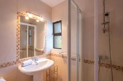a bathroom with a sink and a shower at Apartment Luna - Resort with a pool area with a lounge bar in Albufeira